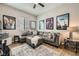 Inviting living room with a plush gray sectional sofa, soft rug, and decor at 8032 Audubon Canyon St, Las Vegas, NV 89131