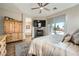 Bright main bedroom with sliding glass door to pool, ceiling fan, and tiled fireplace at 8032 Audubon Canyon St, Las Vegas, NV 89131