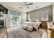 Bright main bedroom with sliding glass door to patio, ceiling fan, and tiled fireplace at 8032 Audubon Canyon St, Las Vegas, NV 89131