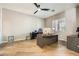 Bright office space featuring wood-look flooring, a ceiling fan, and a large window for natural light at 8032 Audubon Canyon St, Las Vegas, NV 89131