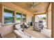 Comfortable covered patio with ceiling fans, outdoor seating, and view of backyard pool at 8032 Audubon Canyon St, Las Vegas, NV 89131