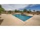 Backyard with a refreshing pool, spa, and desert landscaping and mature trees at 8032 Audubon Canyon St, Las Vegas, NV 89131