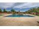 Inviting backyard pool with water features, pristine concrete deck, and lush landscaping at 8032 Audubon Canyon St, Las Vegas, NV 89131