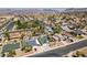 Wide aerial view of a neighborhood with single-Gathering homes and tree-lined streets, mountains in background at 813 Cherry Dr, Henderson, NV 89002