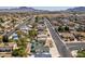 Aerial view of a residential neighborhood with houses, streets, and desert landscape at 813 Cherry Dr, Henderson, NV 89002