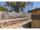 Exterior shot of a backyard featuring a rock planter and a cinder block fence at 813 Cherry Dr, Henderson, NV 89002