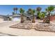 Well maintained single Gathering home with lush, mature palms in decorative rock beds at 813 Cherry Dr, Henderson, NV 89002