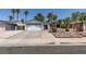 Single-story home with a two-car garage, mature landscaping, and a well-maintained front yard at 813 Cherry Dr, Henderson, NV 89002