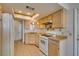 Kitchen with wooden cabinets, white appliances, tile floors and skylight at 813 Cherry Dr, Henderson, NV 89002