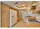 Well-lit kitchen boasts light wood cabinetry, a gas range, and white appliances at 813 Cherry Dr, Henderson, NV 89002