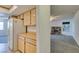 View of the kitchen cabinets and appliances, with an adjacent living space featuring a fireplace at 813 Cherry Dr, Henderson, NV 89002