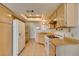 Bright kitchen features light wood cabinets, white appliances, and ample counter space at 813 Cherry Dr, Henderson, NV 89002