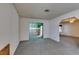 Open living room with neutral carpet and sliding door to a sunroom at 813 Cherry Dr, Henderson, NV 89002