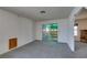 Bright living room featuring neutral carpet and sliding door to a sunroom at 813 Cherry Dr, Henderson, NV 89002