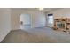 Living room with fireplace, view to the dining and living areas and neutral-colored carpet at 813 Cherry Dr, Henderson, NV 89002
