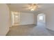 Open living room featuring neutral carpet and views into the entryway and hallways at 813 Cherry Dr, Henderson, NV 89002