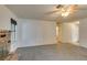 Bright living room with a brick fireplace, neutral carpet, and a ceiling fan at 813 Cherry Dr, Henderson, NV 89002