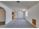 Spacious living room featuring neutral carpet, bright natural light, and an open layout at 813 Cherry Dr, Henderson, NV 89002