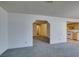 Open living room with neutral carpet and views into the hallways and kitchen at 813 Cherry Dr, Henderson, NV 89002