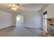 Spacious living room with neutral carpet, fireplace, ceiling fan, and ample natural light at 813 Cherry Dr, Henderson, NV 89002