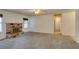 Spacious living room featuring a brick fireplace, ceiling fan, and neutral carpet at 813 Cherry Dr, Henderson, NV 89002