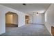 Open-concept living room with neutral carpet and access to kitchen and dining areas at 813 Cherry Dr, Henderson, NV 89002