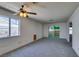 Inviting living room with slider door, window, ceiling fan and easy access to kitchen at 813 Cherry Dr, Henderson, NV 89002