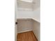 Interior view of empty closet with wooden shelving and hardwood floors at 831 Purple Sage Ter, Henderson, NV 89015