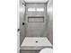 Modern shower features gray tile, sleek hardware, and built in niche for storage at 831 Purple Sage Ter, Henderson, NV 89015