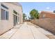 Open backyard featuring a concrete patio, easy-care landscaping, and block wall for privacy at 9011 Aldershot Ct, Las Vegas, NV 89147
