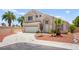 Charming two-story home featuring desert landscaping, a two-car garage, and a spacious driveway at 9011 Aldershot Ct, Las Vegas, NV 89147