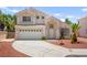 Beautiful two-story home boasting an attached garage, desert landscaping, and a neutral color palette at 9011 Aldershot Ct, Las Vegas, NV 89147