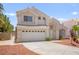 Attractive two-story home featuring a two-car garage, easy-care landscaping, and an inviting entrance at 9011 Aldershot Ct, Las Vegas, NV 89147