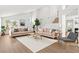 Open-concept living room featuring high ceilings, wood floors, and contemporary furnishings at 9011 Aldershot Ct, Las Vegas, NV 89147