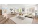 Inviting living room connected to dining area, featuring stylish décor and plenty of natural light at 9011 Aldershot Ct, Las Vegas, NV 89147