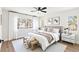 Serene bedroom with a king-sized bed, soft lighting, and a view of palm trees at 9011 Aldershot Ct, Las Vegas, NV 89147