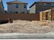 A new home can be built on this empty lot that sits between existing homes and has utility hookups at 9113 Rivington Ave, Las Vegas, NV 89148