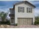 Charming two-story home with a neutral colored exterior, a two-car garage, and well-placed shuttered windows at 9113 Rivington Ave, Las Vegas, NV 89148