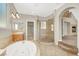 Bright bathroom features a jacuzzi tub, glass shower, and access to the bedroom at 9225 Dalmahoy Pl, Las Vegas, NV 89145