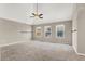 Bright Primary bedroom with vaulted ceiling, ceiling fan, carpet flooring and multiple windows at 9225 Dalmahoy Pl, Las Vegas, NV 89145
