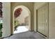Covered entryway featuring an arched opening and a view of the gated side yard at 9225 Dalmahoy Pl, Las Vegas, NV 89145