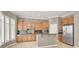 Well-lit kitchen featuring wooden cabinets, stainless steel appliances, and a stylish island at 9225 Dalmahoy Pl, Las Vegas, NV 89145