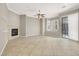 Open living room showcasing tile floors, a fireplace, and a sliding glass door at 9225 Dalmahoy Pl, Las Vegas, NV 89145