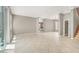 Spacious living room with tile floors, staircase, and access to outdoor patio at 9225 Dalmahoy Pl, Las Vegas, NV 89145