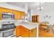 Open-concept kitchen featuring stainless steel appliances, gas range and breakfast bar at 930 High Plains Dr, Henderson, NV 89002