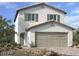 Charming two-story home with a stucco exterior, shuttered windows, and an attached two-car garage at 9546 Marsh Aster St, Las Vegas, NV 89139