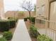 Home exterior featuring stucco walls and lush landscaping, with a private entrance and charming walkway at 10231 Delray Beach Ave # 201, Las Vegas, NV 89129