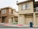 Two-story townhomes with neutral stucco exteriors and attached garages at 10231 Delray Beach Ave # 201, Las Vegas, NV 89129