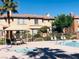 Community pool area with seating, palm trees, and lush landscaping offers a relaxing outdoor space at 10231 Delray Beach Ave # 201, Las Vegas, NV 89129