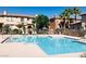 Community pool area surrounded by lounge chairs, palm trees, and well-maintained landscaping at 10231 Delray Beach Ave # 201, Las Vegas, NV 89129